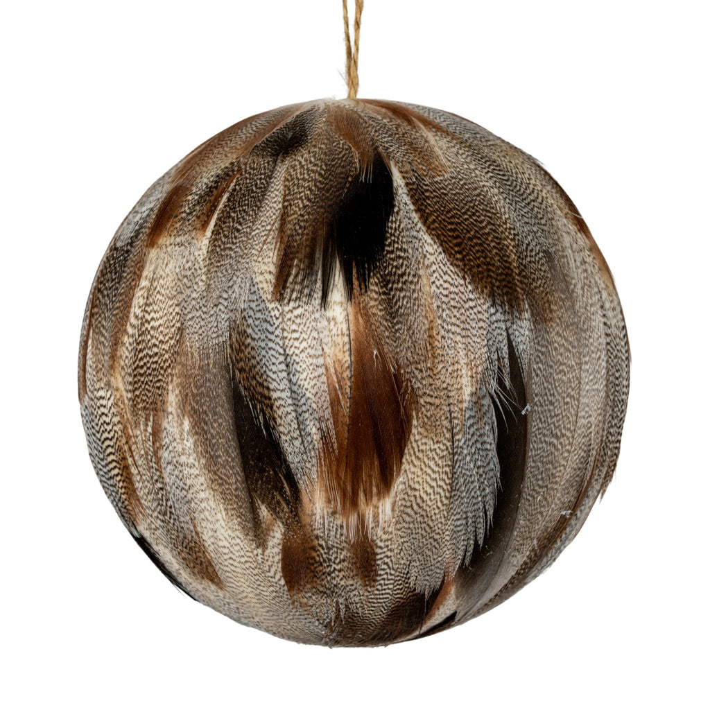 Close-up of the bauble's overlapping feather-like elements, showing fine dark markings, warm brown patches and wispy edges.