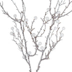 Close-up of the angular twig branches, showing their textured silver-coloured surface, scattered sparkle and translucent white spherical ornaments.