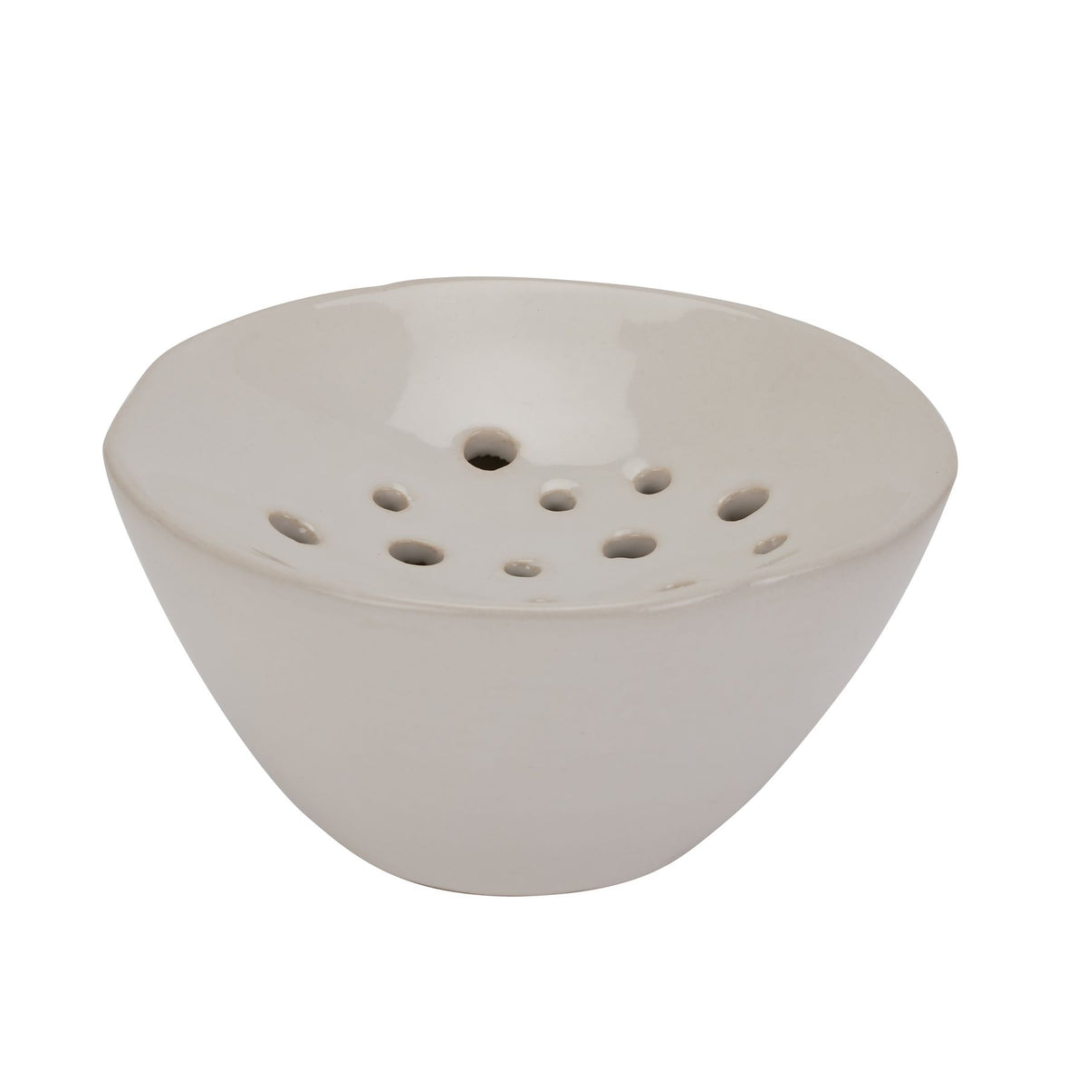 Off-white flower-frog vase viewed at an angle, showing its curved bowl sides, flared rim and recessed perforated top.