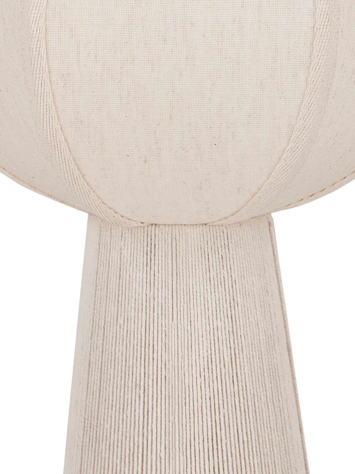 Detail of the woven cream shade and its curved textured bands where it meets the rope-covered lamp base.