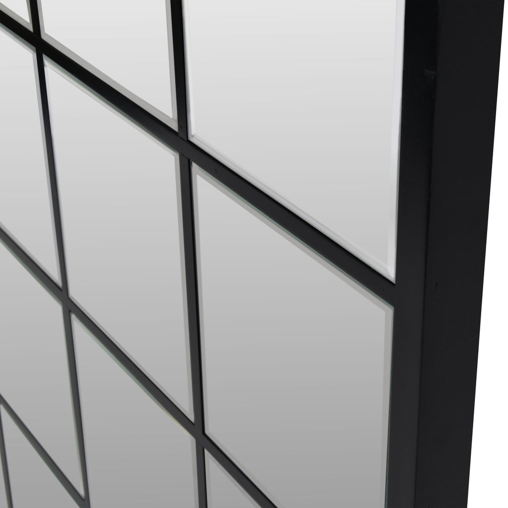 Angled close-up of the Pier mirror showing bevelled glass panes, black grid divisions and the depth of the outer frame.