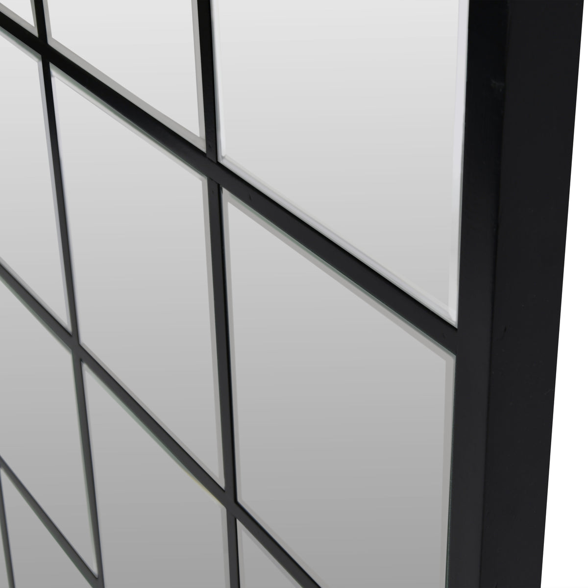 Angled close-up of the Pier mirror showing bevelled glass panes, black grid divisions and the depth of the outer frame.