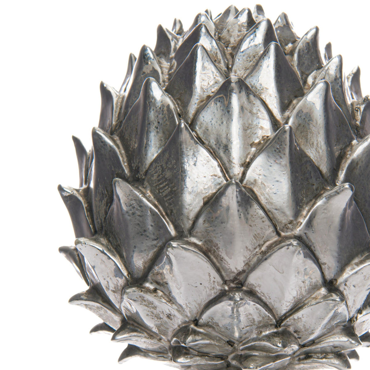 Close-up of the pinecone finial's layered pointed scales, showing bright silver-coloured ridges and darker mottled recesses.