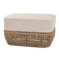 Piped Basketfoot Footstool shown at an angle, with a thick pale beige cushion above a brown open basket-weave base.