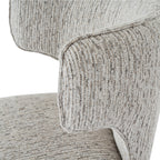 Close-up of the curved back wing with piped edging and raised pale stripes over fine darker threads.