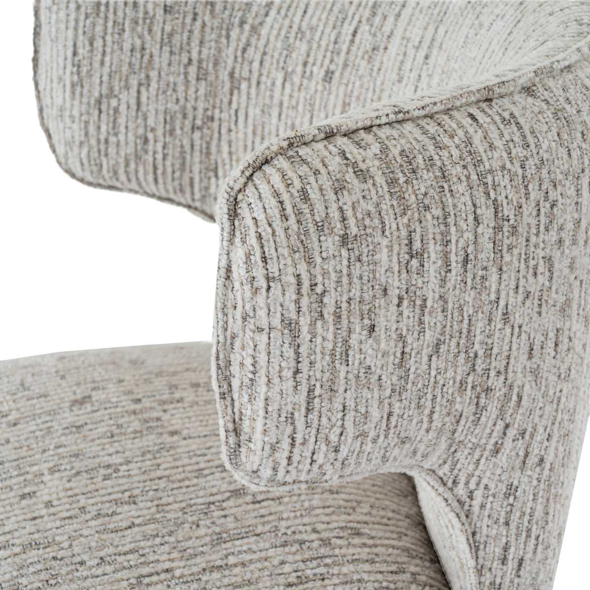Close-up of the curved back wing with piped edging and raised pale stripes over fine darker threads.