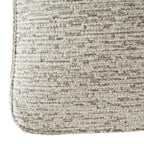 Detail of the mist-grey upholstery with small raised loops, fine contrasting threads and piping around the rounded lower edge.