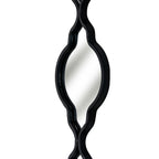 Angled close-up of a mirrored section showing the depth of its black edging around the curved sides and pointed lower end.