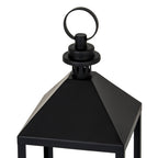 Close view of the lantern's black pyramidal roof, showing the slotted cylindrical cap, stepped circular top and round loop ring.