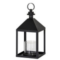 Three-quarter view of a black candle lantern with a square base, four upright posts, clear cylindrical inner holder and pyramidal top beneath a round ring.