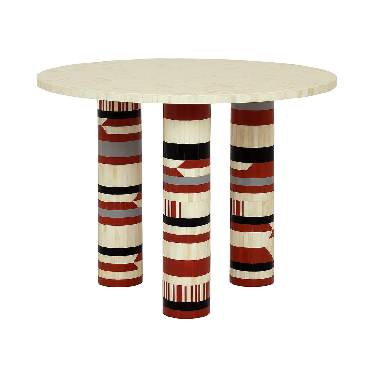 Quatrefoil dining table with a circular cream top and three patterned cylindrical legs, one facing forward.