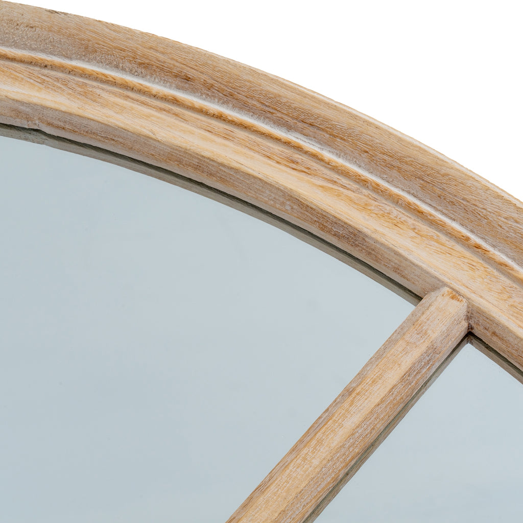 Close-up of the mirror's curved outer frame and one diagonal bar, showing pale whitewashed colouring over warm wood-tone grain and a shallow groove along the rim.