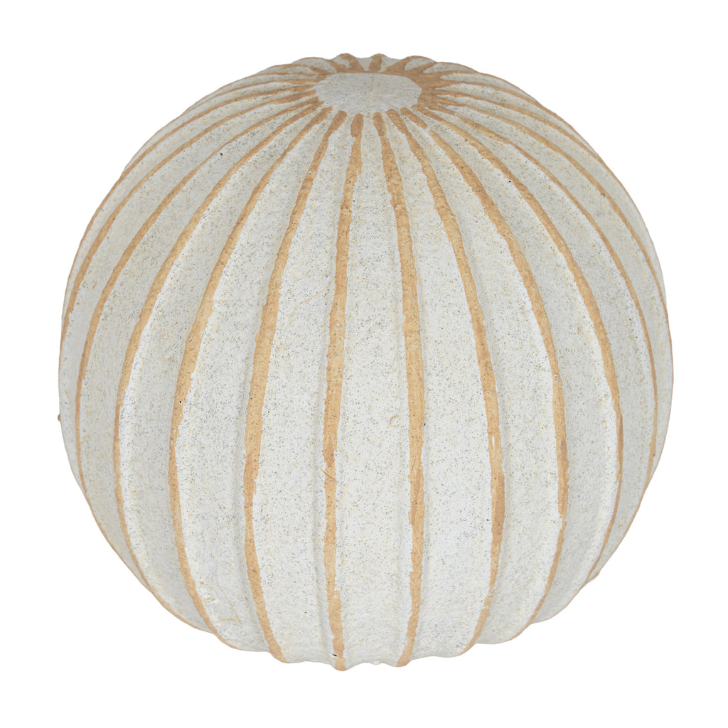 Decorative ball viewed from above at an angle, showing tan lines radiating around a pale circular area at the top.
