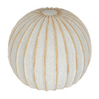 Decorative ball viewed from above at an angle, showing tan lines radiating around a pale circular area at the top.