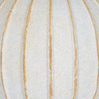 Detail of the vase body showing fine speckling, a granular cream-white surface and uneven tan grooves.