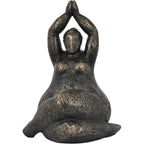 Front view of a bronze-finish seated feminine figure sculpture with folded legs and palms joined overhead.