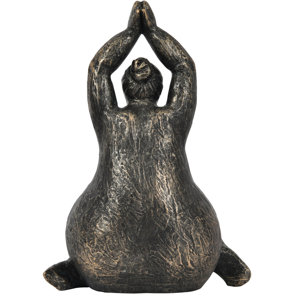 Rear view of the raised-arms figure sculpture showing a sculpted hair bun and textured back.