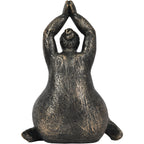 Rear view of the raised-arms figure sculpture showing a sculpted hair bun and textured back.