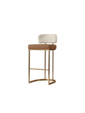 Three-quarter view of a bar stool with a cognac seat, light barley raised backrest and brass-toned frame with a front footrest and curved base.