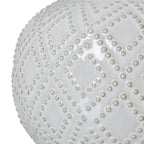 Close-up of the glossy white lamp base showing raised beads arranged in a repeating diamond pattern.