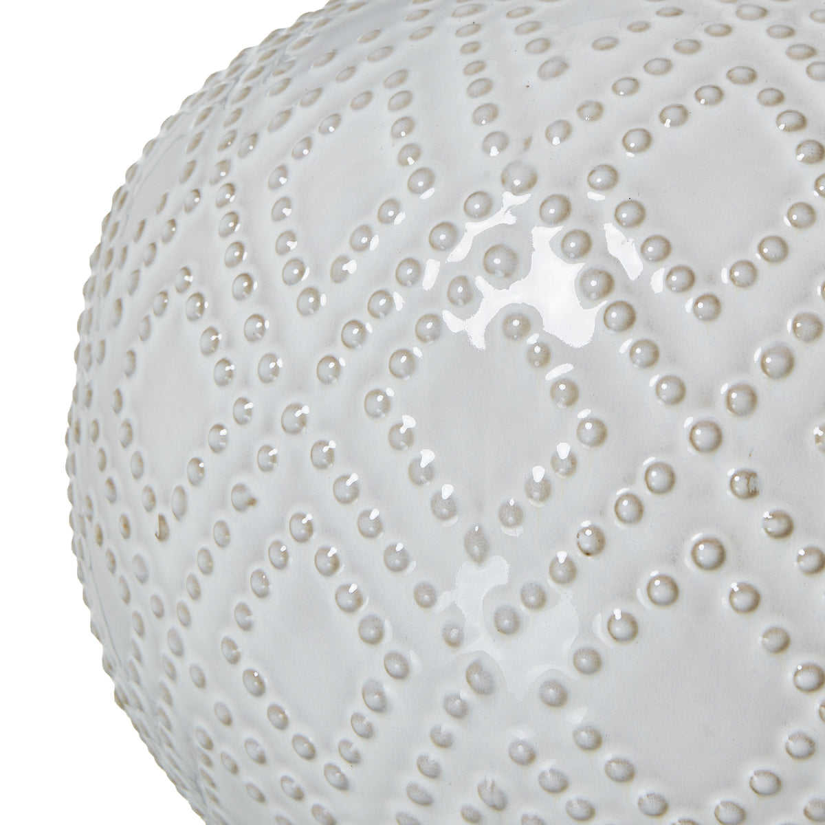Close-up of the glossy white lamp base showing raised beads arranged in a repeating diamond pattern.