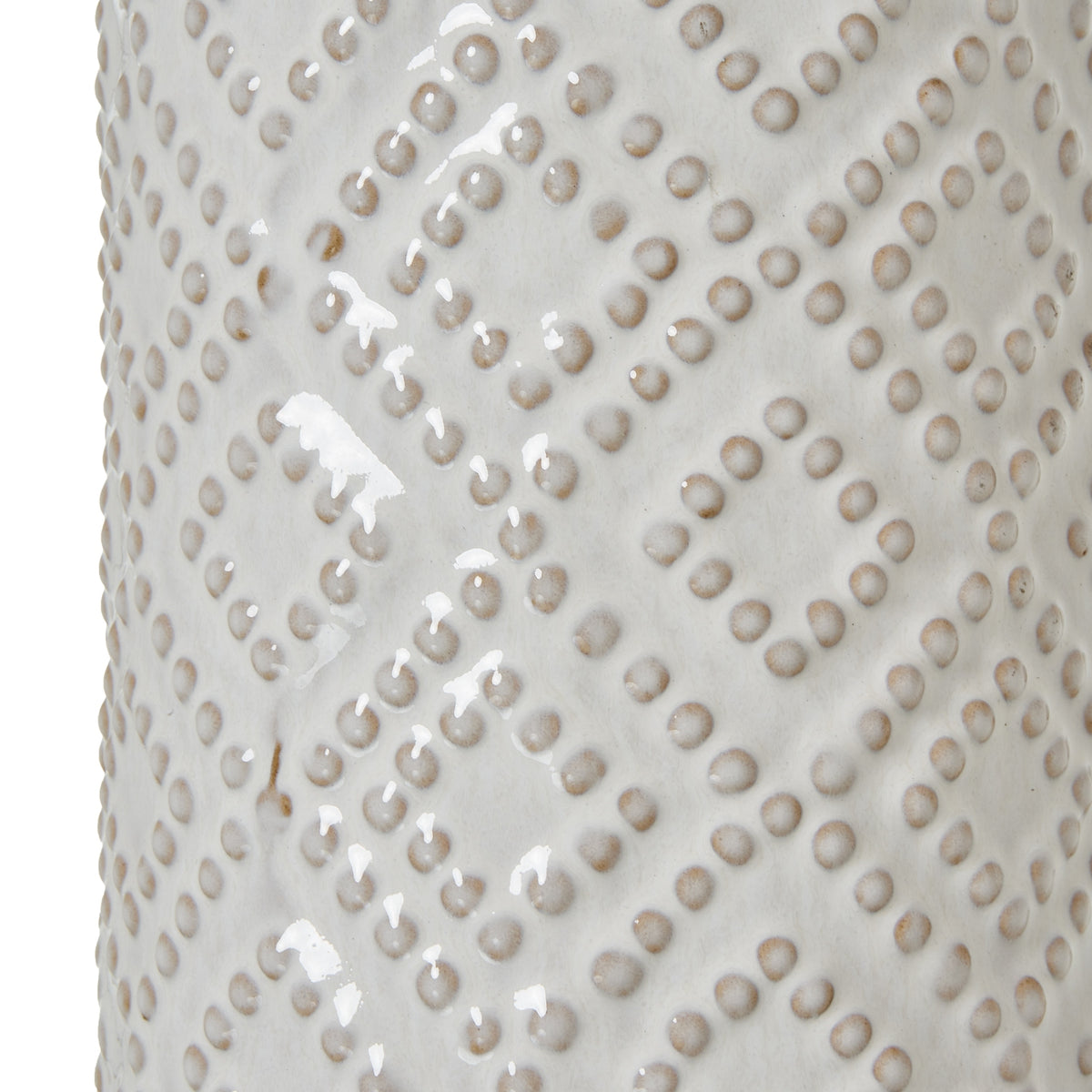 Close-up of the glossy off-white lamp base, showing rounded raised dots in diagonal diamond bands with warm beige shading.