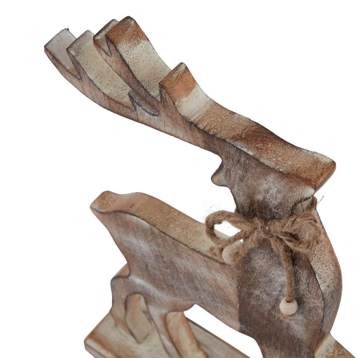 Angled close-up of the reindeer ornament showing the pale edges of its antlers and the rope bow around its neck.