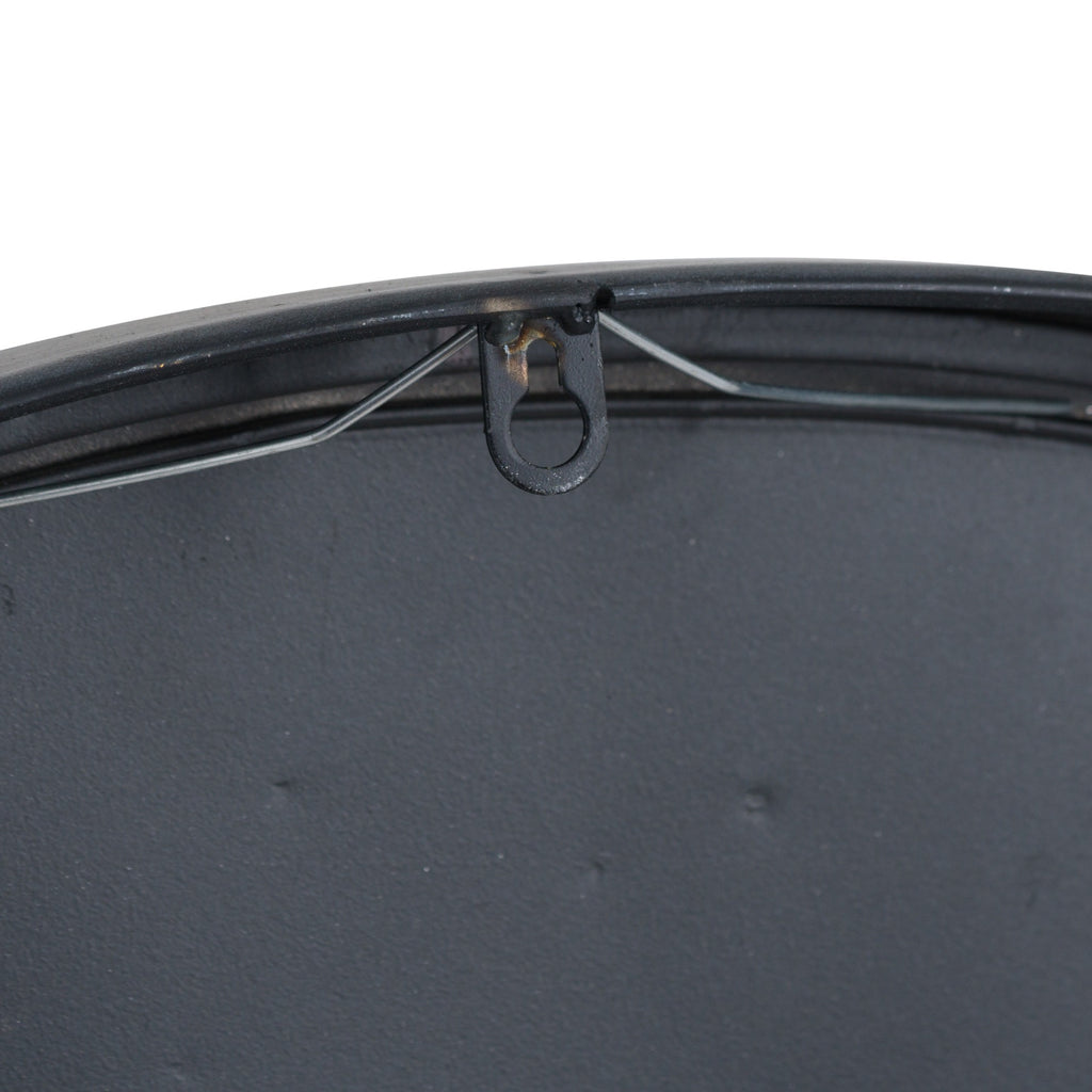 Rear detail of the clock showing its black backing, central hanging loop and a wire running beneath the upper rim.