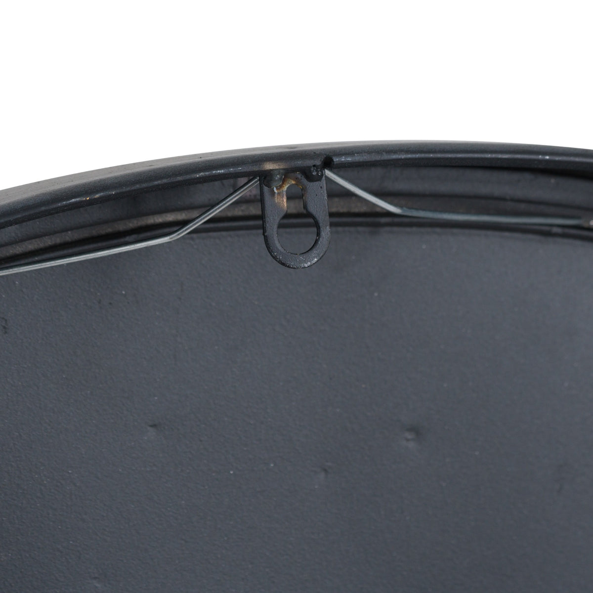 Rear detail of the clock showing its black backing, central hanging loop and a wire running beneath the upper rim.