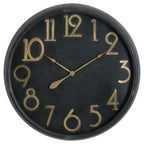 Round black wall clock with raised gold-toned Arabic numerals, matching slender hands and a dark rounded rim.