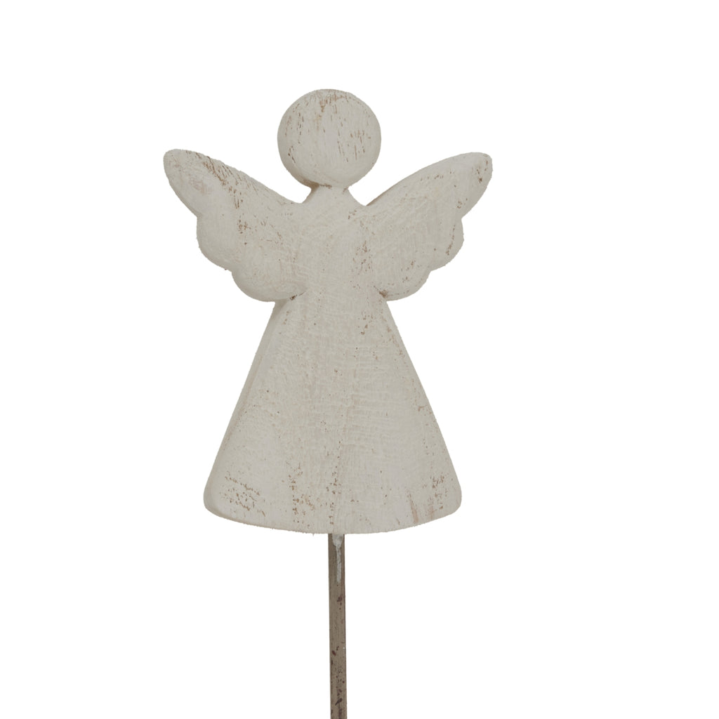 Close-up of the angel figure showing scalloped wing edges and darker marks through the pale whitewashed finish.