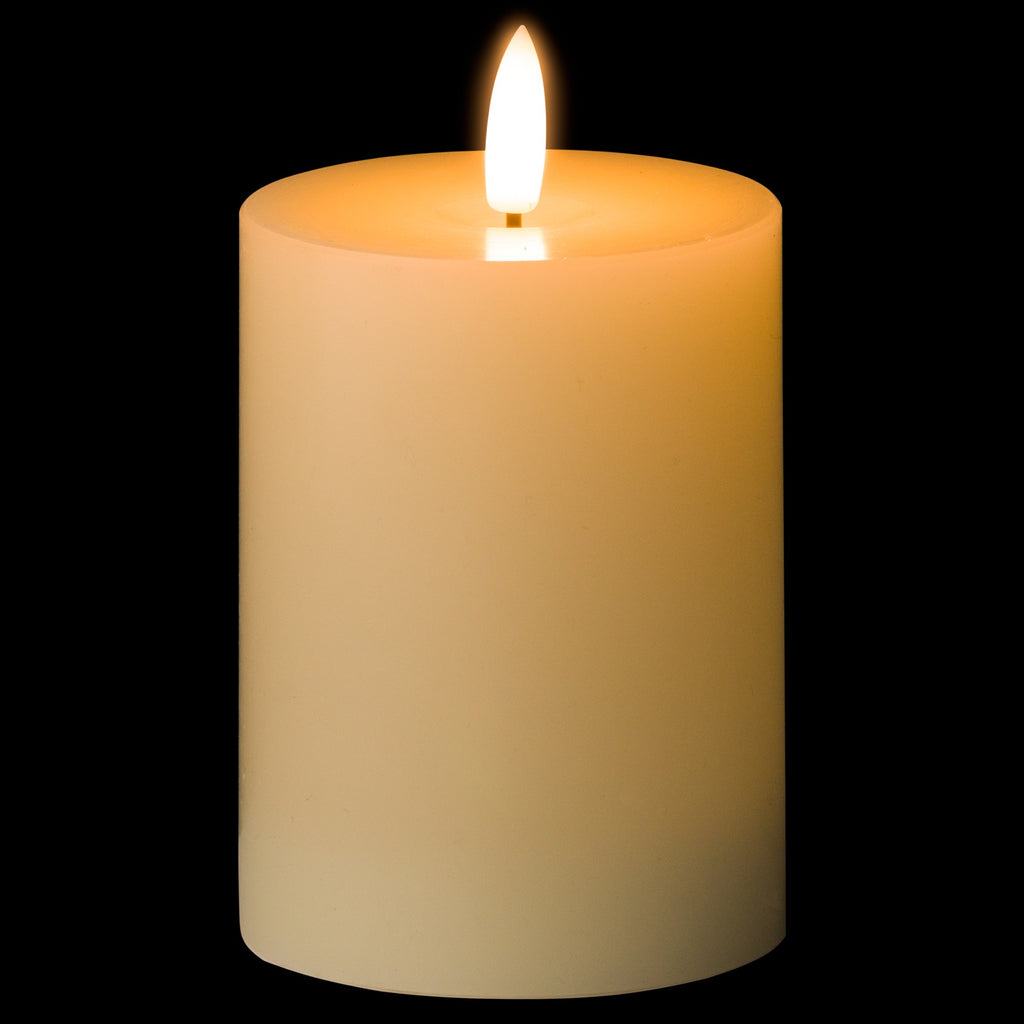 LED candle illuminated against a black background, showing a bright flame-shaped element and warm amber glow across the ivory body.