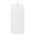 White pillar LED candle against a white background, showing its rounded top, shallow recess and unlit flame-shaped element on a short dark stem.
