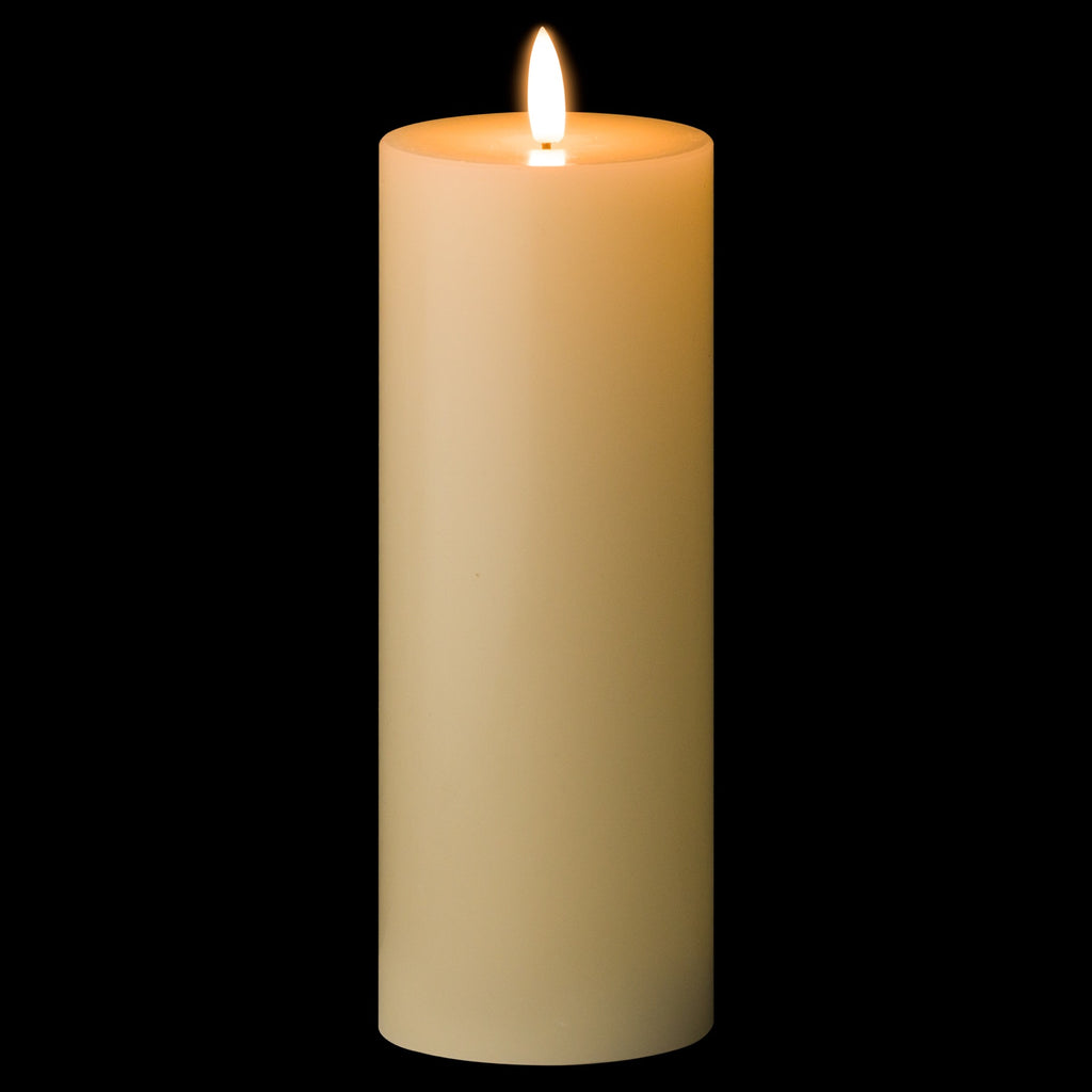 Ivory pillar candle shown against a black background, with a bright white flame-shaped element and an amber appearance around the recessed top.