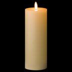 Ivory pillar candle shown against a black background, with a bright white flame-shaped element and an amber appearance around the recessed top.