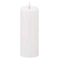 White pillar candle against a white background, showing smooth cylindrical sides, a rounded top edge and an unlit white flame-shaped element on a short dark stem.