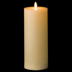 Ivory cylindrical LED candle pictured against black, with a bright flame-shaped element and amber tones around the recessed top.