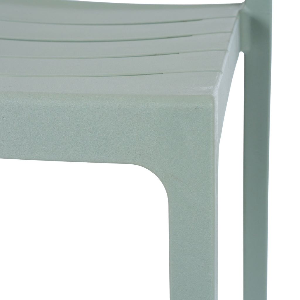 Close-up of the green-grey chair's slatted seat, curved seat edge and legs, showing the matte, finely pebbled surface.