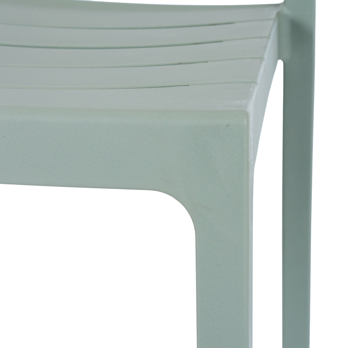 Close-up of the green-grey chair's slatted seat, curved seat edge and legs, showing the matte, finely pebbled surface.