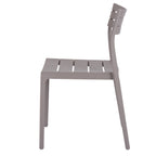 Side view of the grey dining chair, showing the gently reclined back, gaps in the seat and slightly splayed legs.