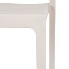 Close-up of the pale putty chair's seat edge and front leg, showing the fine pebbled texture and rounded inner corner.