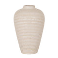 Cream vase with dense rows of tan rectangular impressions, scattered dark specks, rounded shoulders and a tapered body against a white background.