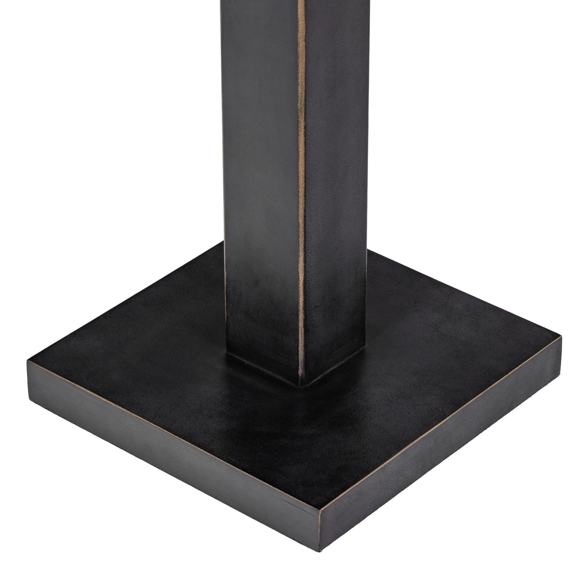 Detail of the dark square base and rectangular stem, with fine warm-toned edging along the corners.