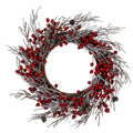 Full view of a circular artificial wreath with glossy red berry clusters, white and silver-dusted brown branches and scattered pinecones around an open centre.