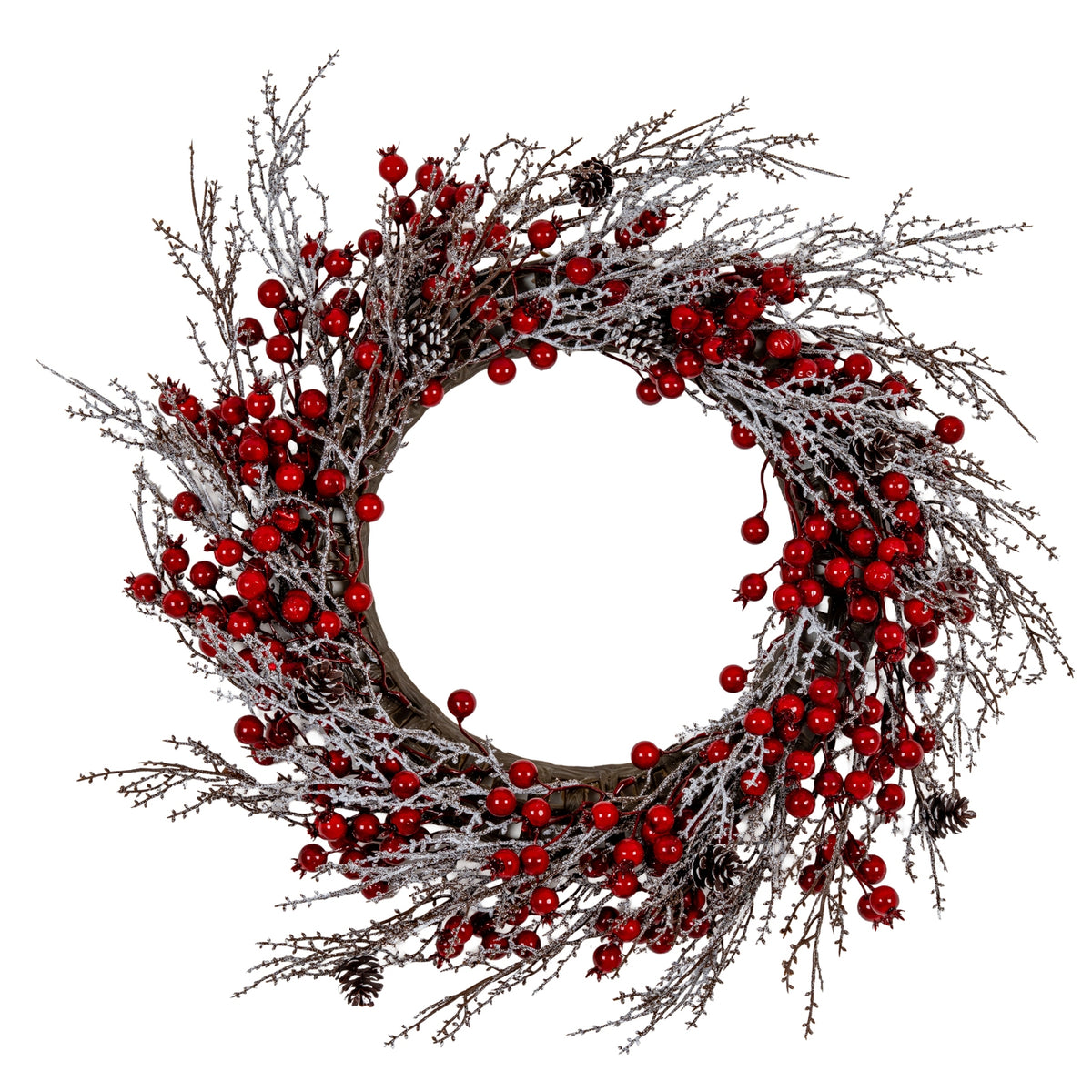 Full view of a circular artificial wreath with glossy red berry clusters, white and silver-dusted brown branches and scattered pinecones around an open centre.