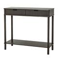 Angled view of a dark grey-brown console table with two reeded drawer fronts, dark cup pulls, four turned-profile legs and a lower shelf on a white background.