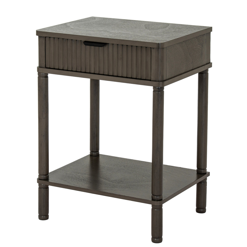 Three-quarter view of the dark grey-brown Reed & Cup Side Table, showing its reeded drawer front, plain side panel and lower shelf.