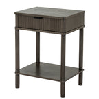 Three-quarter view of the dark grey-brown Reed & Cup Side Table, showing its reeded drawer front, plain side panel and lower shelf.