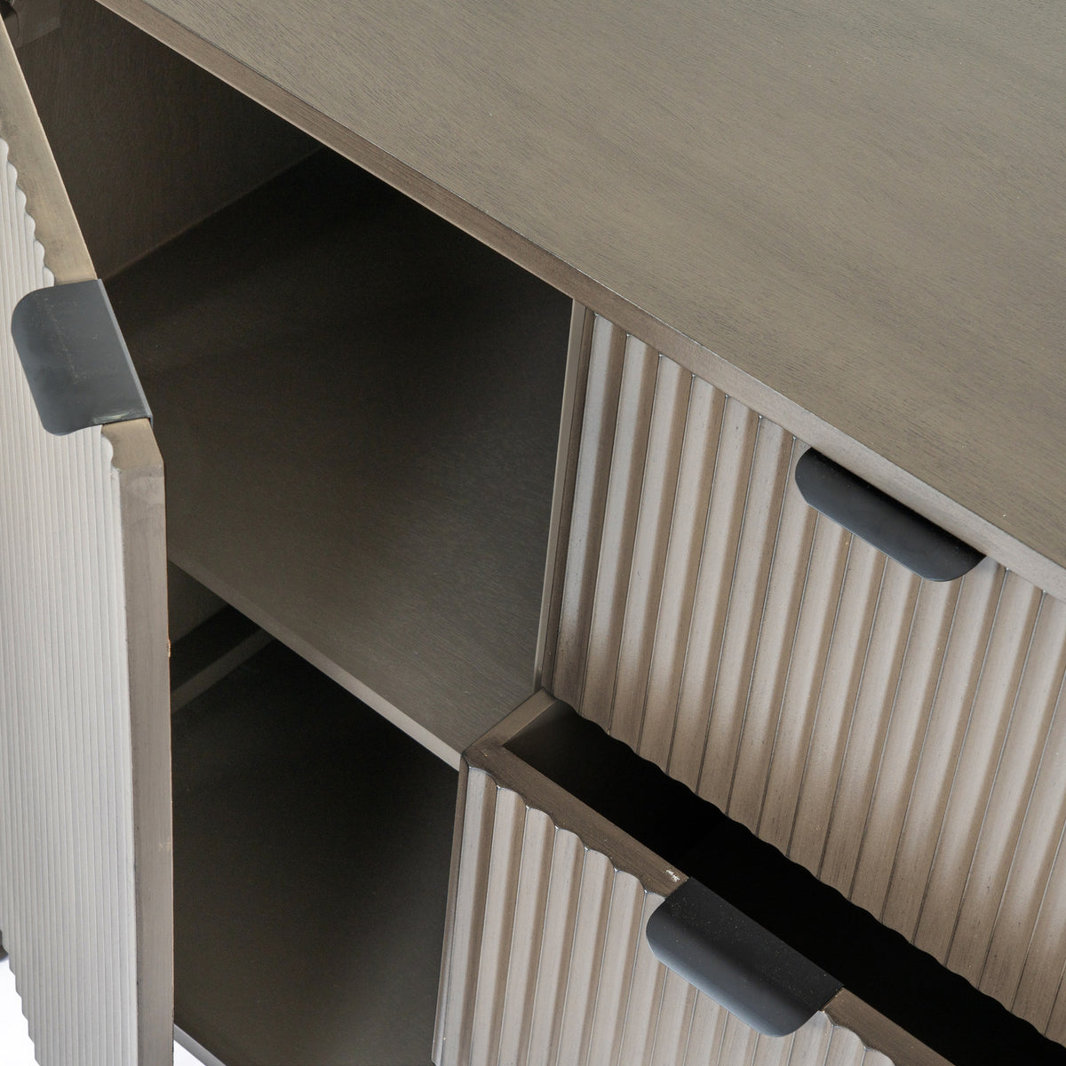 Angled detail of the sideboard with the left door open to reveal an internal shelf and a central drawer partly pulled out.