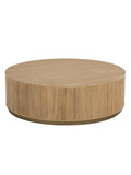 Round pale oak coffee table viewed from above at an angle, showing the wood-grain top, vertically reeded drum sides and narrow gold-coloured base against white.